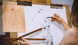 hands using a wood drawing proportional tool on a drawing of a statue